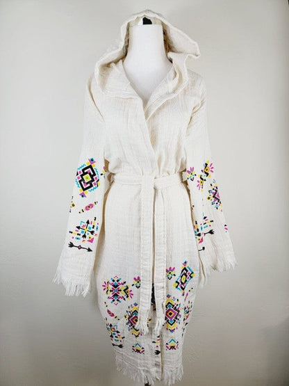 Bohemian white hooded kimono with colorful embroidered geometric patterns, belted waist, and fringed edges.