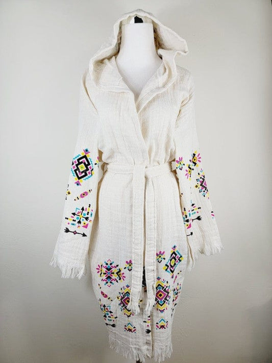 Bohemian white hooded kimono with colorful embroidered geometric patterns, belted waist, and fringed edges.