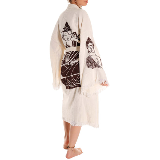 Person wearing a cream-colored kimono with Buddha illustrations on a white background