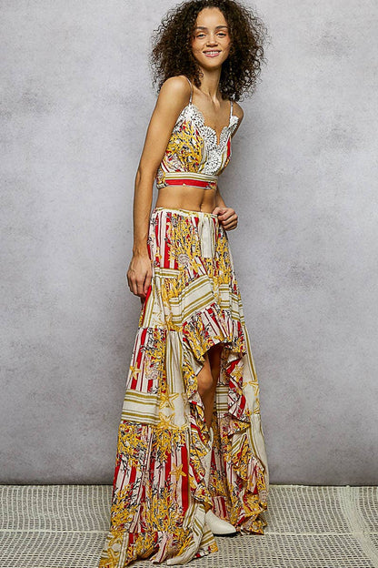 Woman wearing a colorful patterned outfit against a gray background